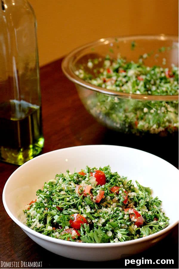 Lemon Quinoa Tabbouleh with Parsley & Mint 4 Quinoa tabbouleh salad in a white bowl.