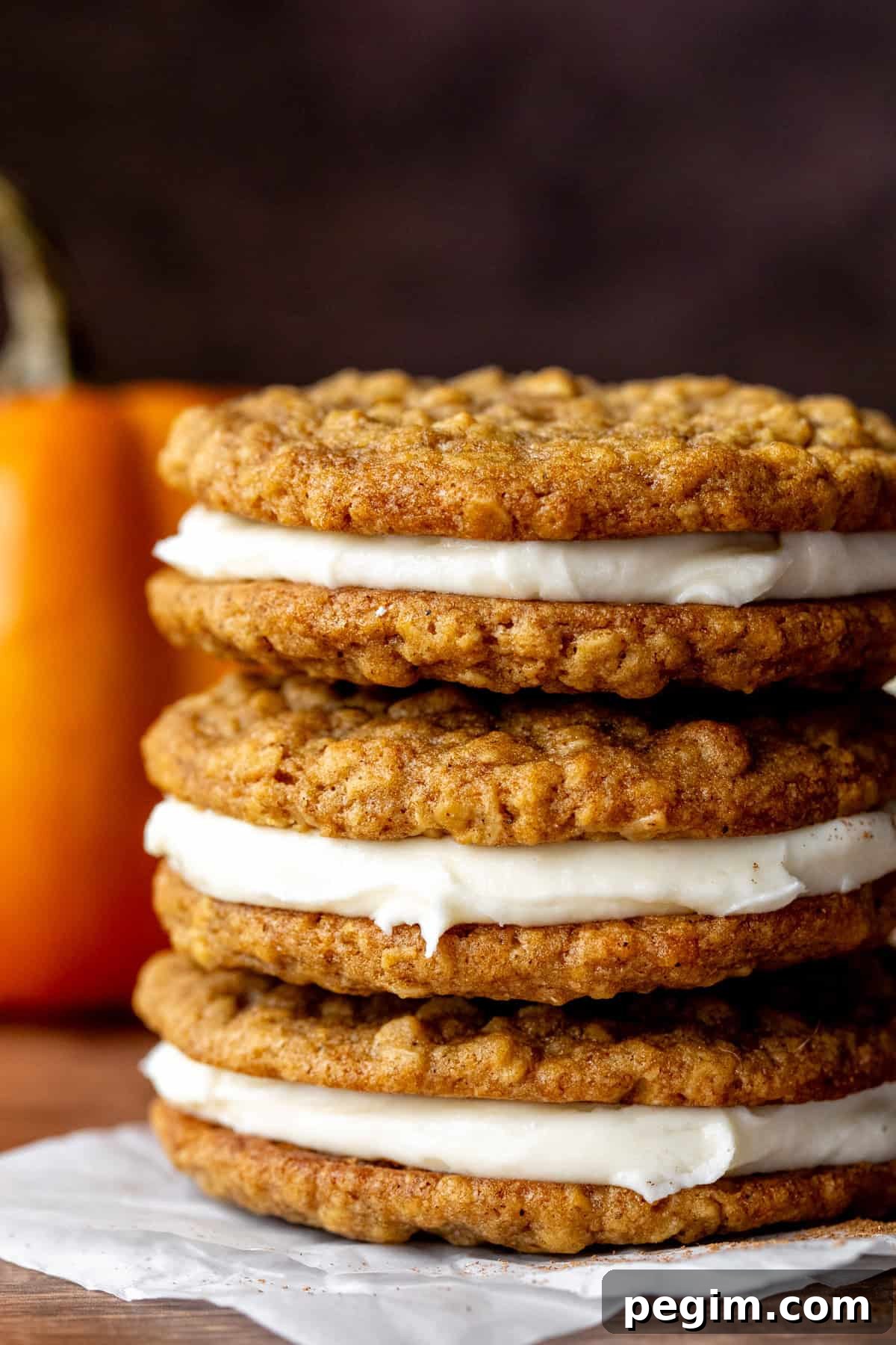 Homemade Pumpkin Oatmeal Cream Pies Recipe 2 Three pumpkin oatmeal cream pie cookies, stacked on top of each other