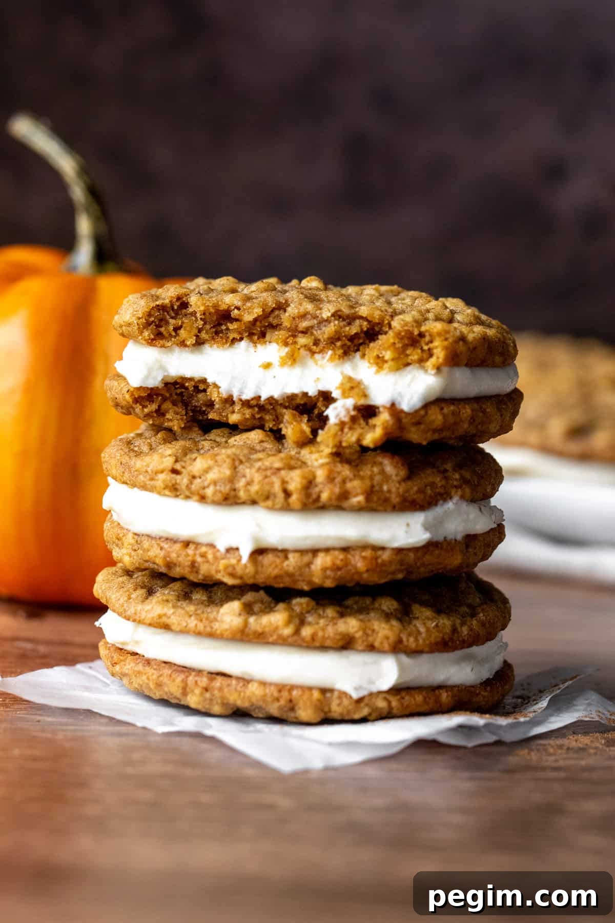 Homemade Pumpkin Oatmeal Cream Pies Recipe 7 Three stacked pumpkin oatmeal cream pies, with top cookie broken in half