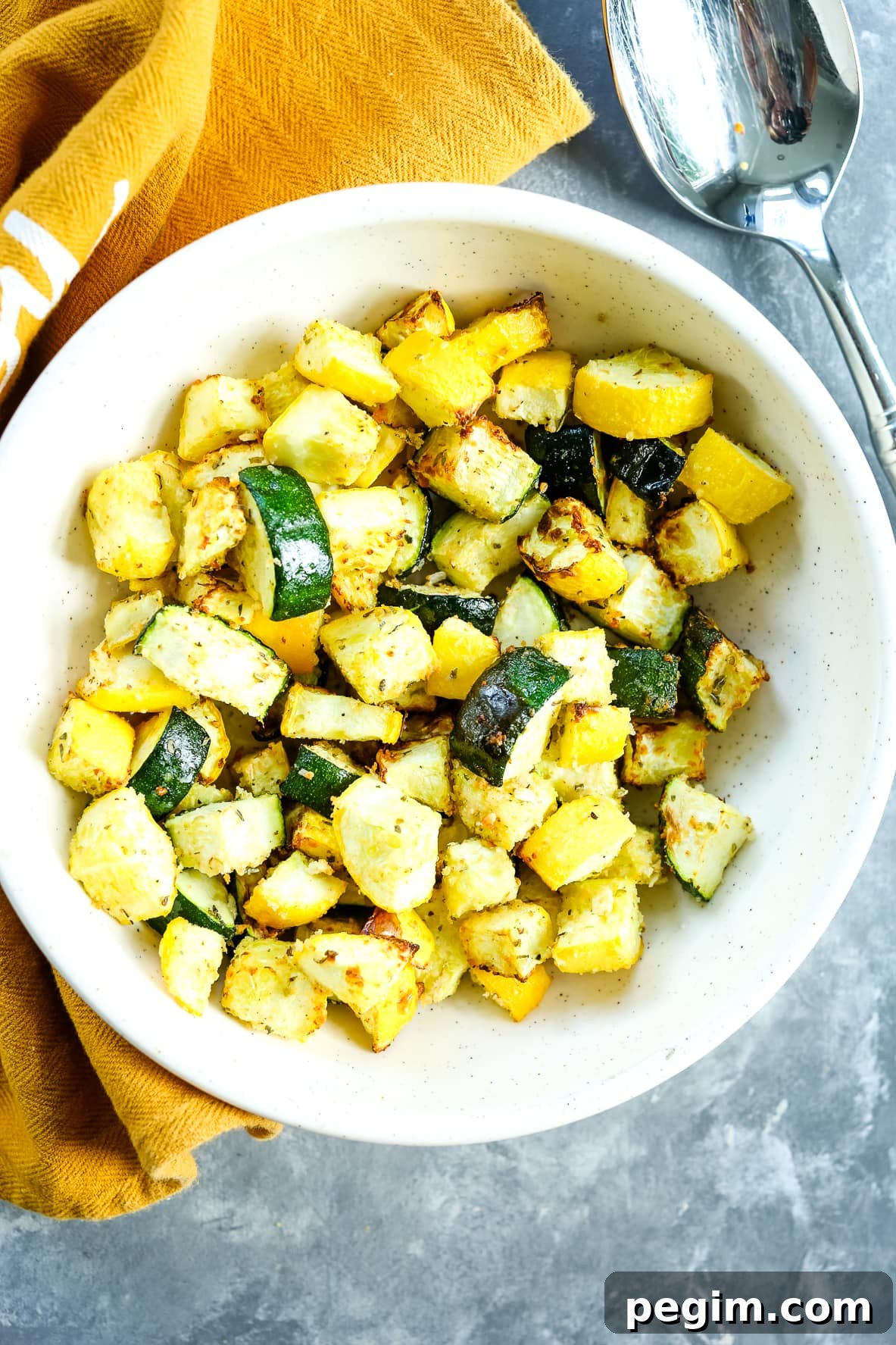 Crispy Air Fryer Zucchini and Yellow Squash in 15 Minutes 2 overhead shot of air fryer zucchini and squash with a brown napkin