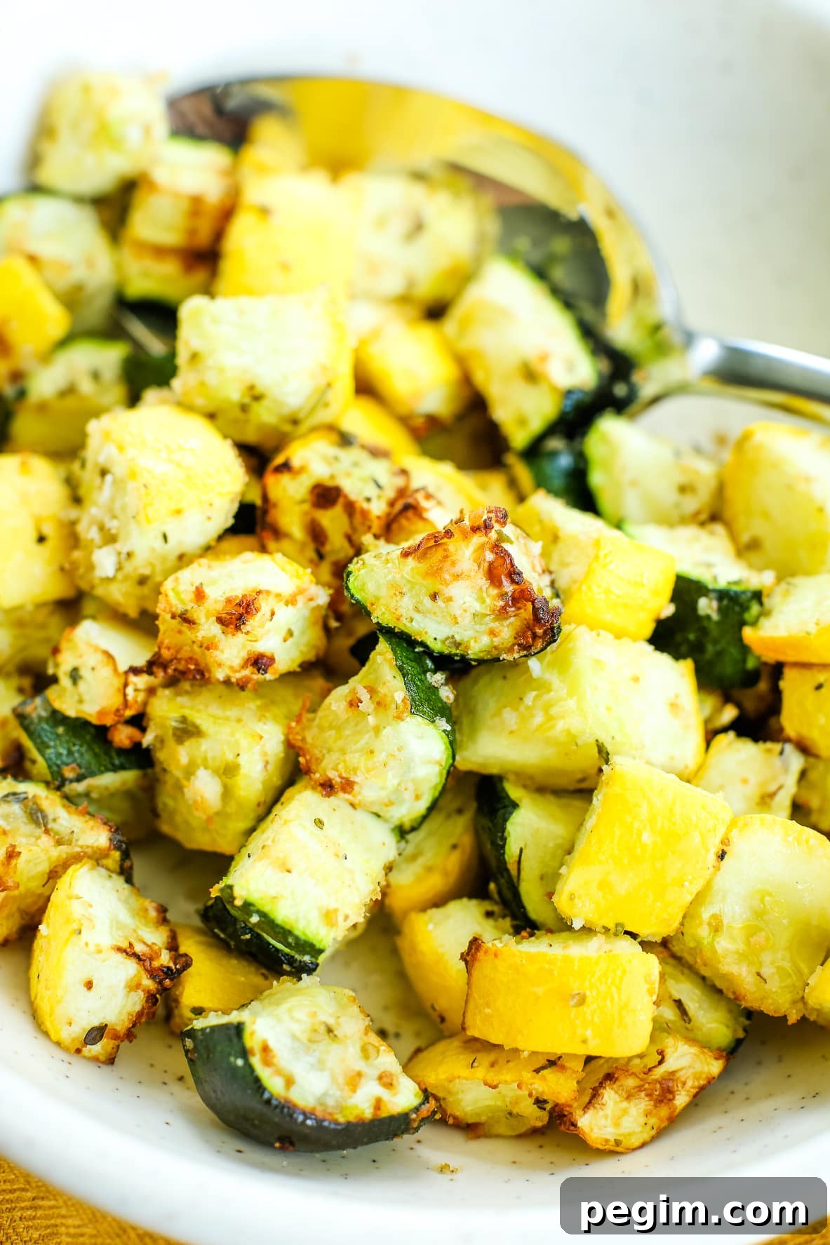 Crispy Air Fryer Zucchini and Yellow Squash in 15 Minutes 4 close up photo of zucchini and squash in a bowl