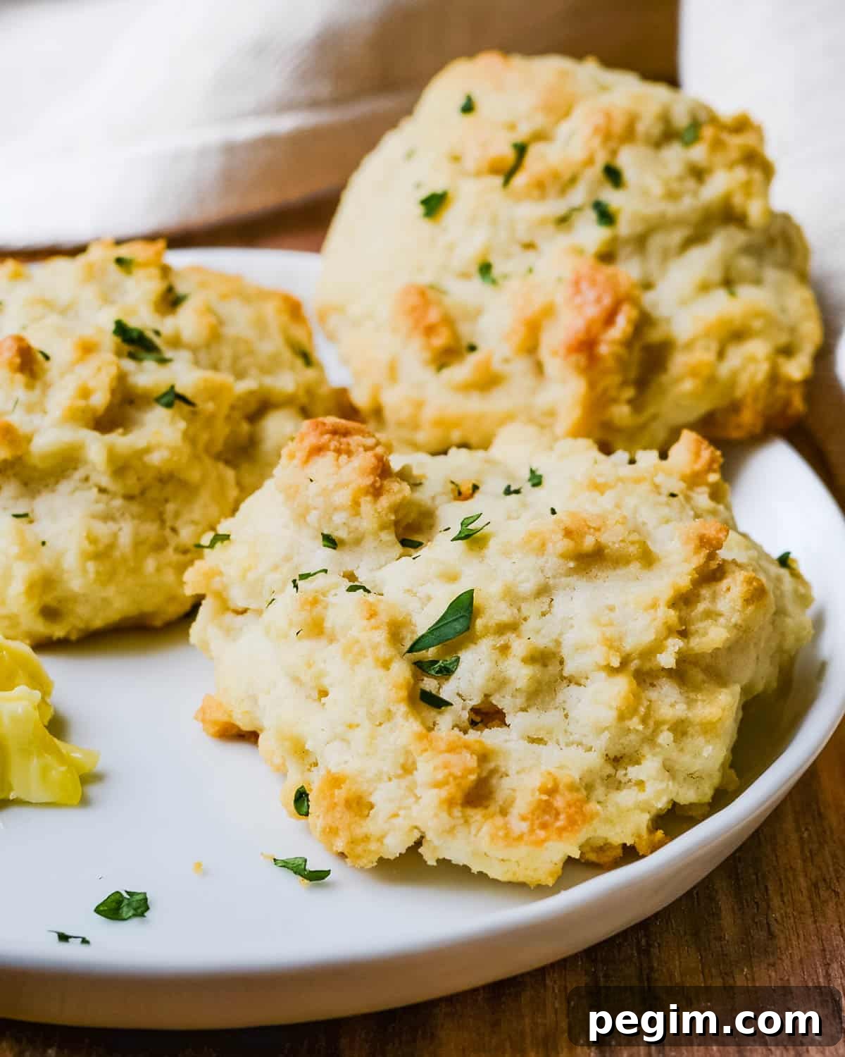 3-Ingredient Drop Biscuits: Quick Homemade Recipe 6 Serving drop biscuits with a pat of butter.