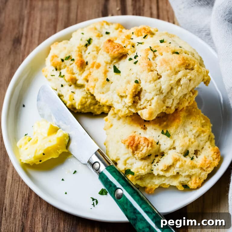 3-Ingredient Drop Biscuits: Quick Homemade Recipe 7 Drop biscuits on a plate with butter.
