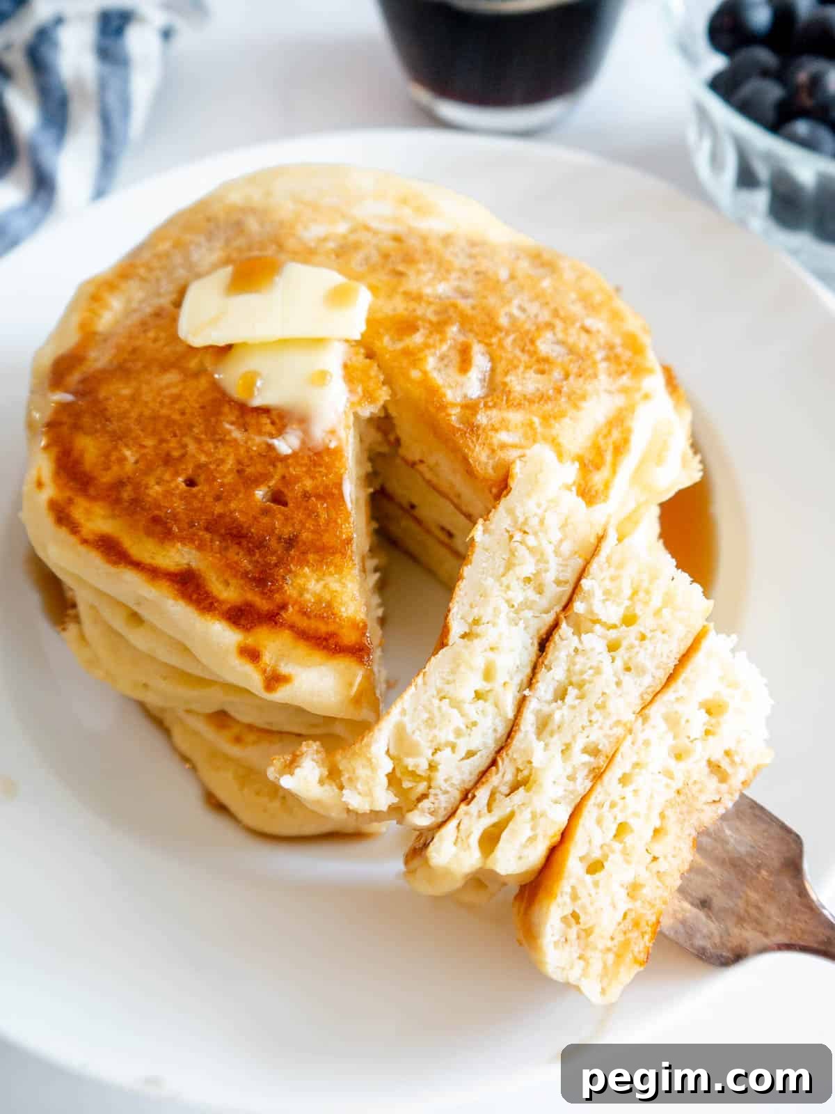 Fluffy Greek Yogurt Pancakes That Stay Light and Tender 2 A bite of fluffy Greek yogurt pancakes on a fork.