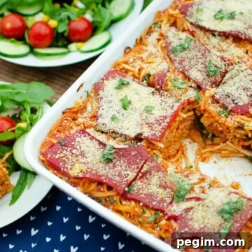 Sun-Dried Tomato & Roasted Pepper Pasta Recipe for Quick Weeknights 3 Sundried Tomato and Roasted Pepper Pasta in a white oven dish and on the side its served on a white plate with salad