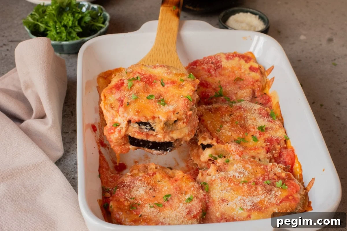 Crispy Baked Eggplant Parmesan Recipe 11 A close up image of eggplant parmesan in a baking dish.