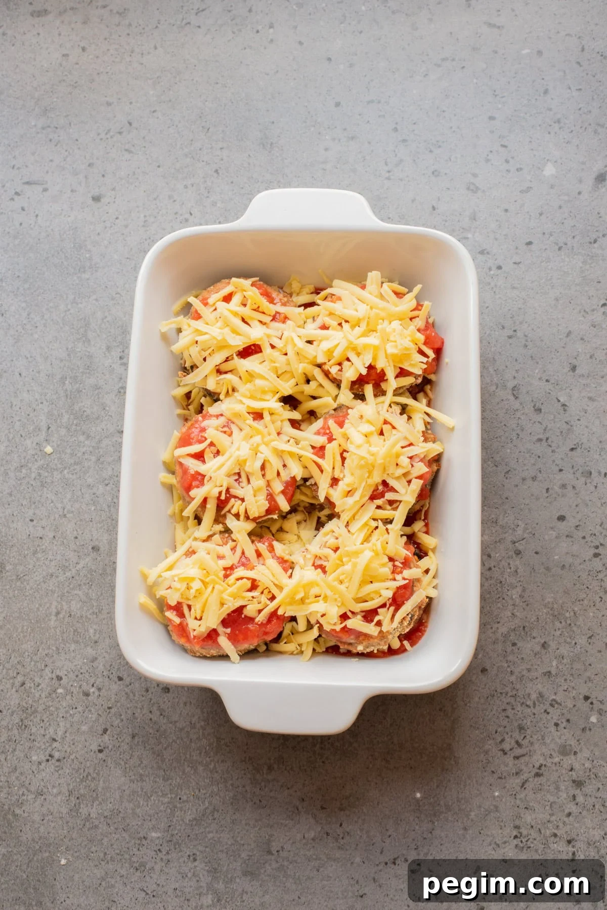 Crispy Baked Eggplant Parmesan Recipe 9 An overhead image of the layered eggplant parmesan in a baking dish.