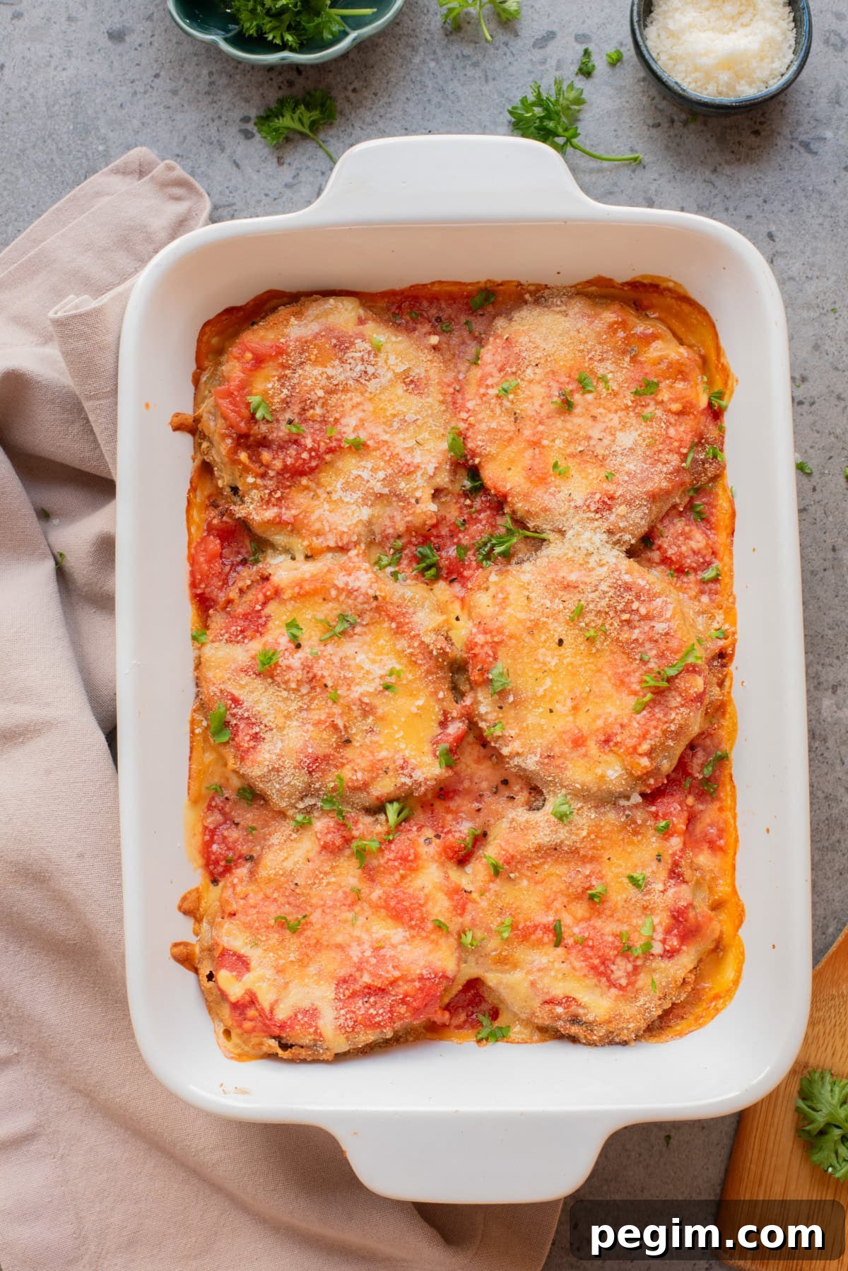 Crispy Baked Eggplant Parmesan Recipe 10 An overhead image of baked eggplant parmesan in a baking dish.