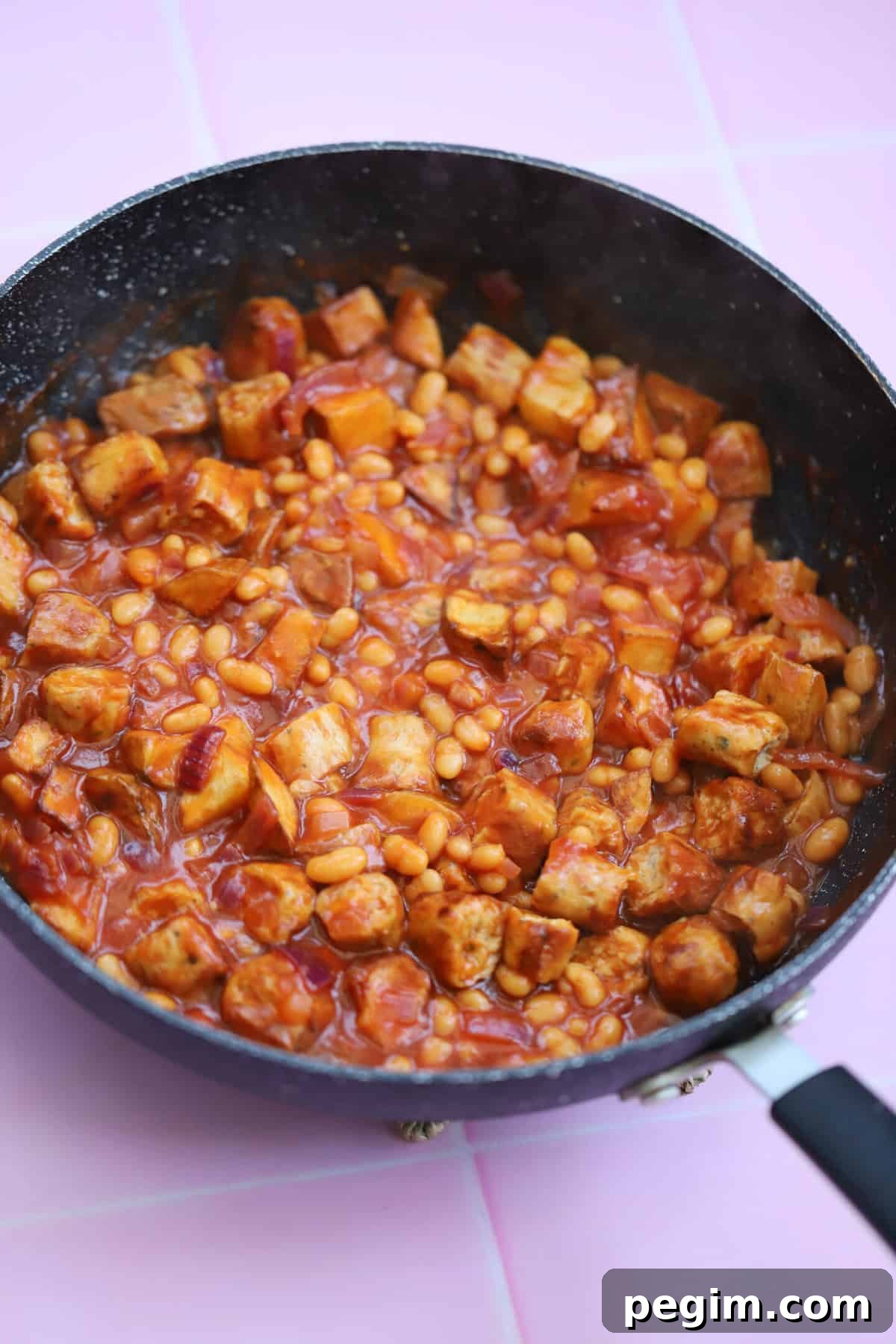 Hearty One-Pan Breakfast Bowl with Eggs and Veggies 3 A pan of chicken sausage pieces, beans and potatoes.