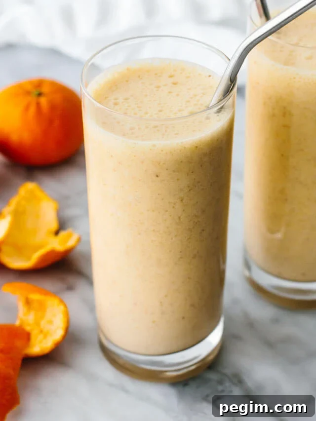 45+ Delicious Vitamix Recipes for Every Meal 6 Mandarin breakfast smoothie in a glass next to mandarins