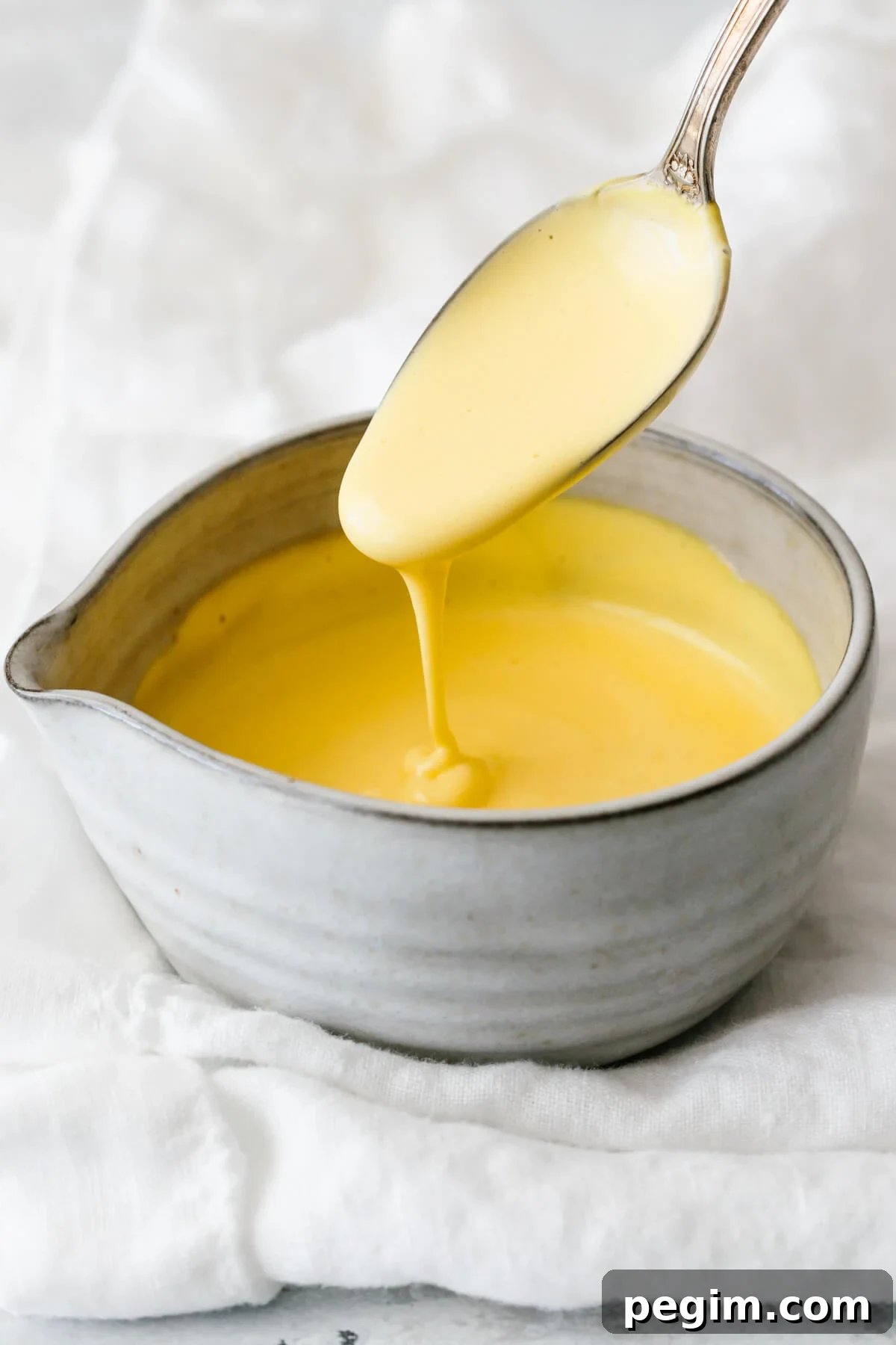 45+ Delicious Vitamix Recipes for Every Meal 9 Hollandaise sauce in a small grey bowl.