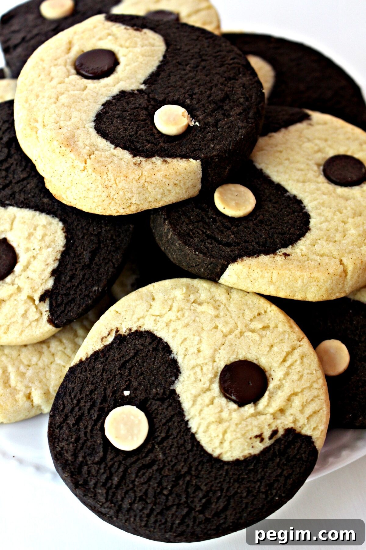 Yin Yang Slice-and-Bake Cookies are crunchy cookies that are simultaneously very vanilla and intensely chocolate, deliciously promoting balance and harmony. Closeup of half chocolate and half vanilla Yin Yang cookie.