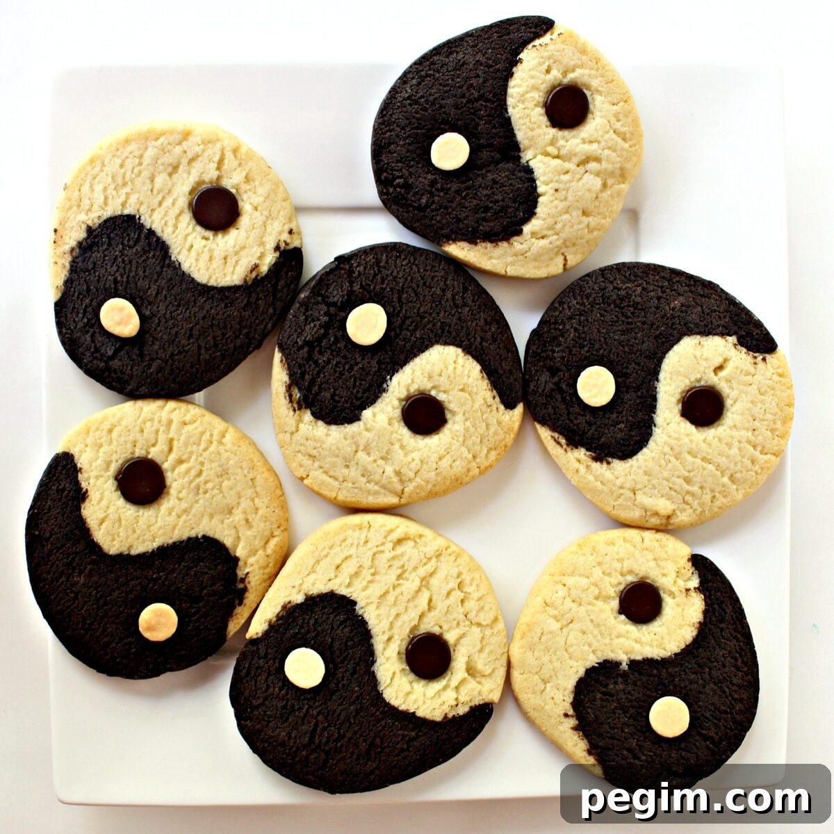 Yin Yang Slice-and-Bake Cookies are crunchy cookies that are simultaneously very vanilla and intensely chocolate, deliciously promoting balance and harmony. Cookies on a white square serving plate.