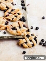 mini blueberry pies with lattice crust on baking tray
