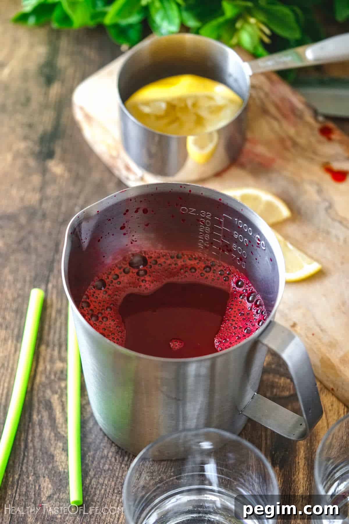 Beetroot Juice Recipes: 2 Ways and Flavor Pairings 9 Freshly squeezed beet juice with apple and carrots in a container.