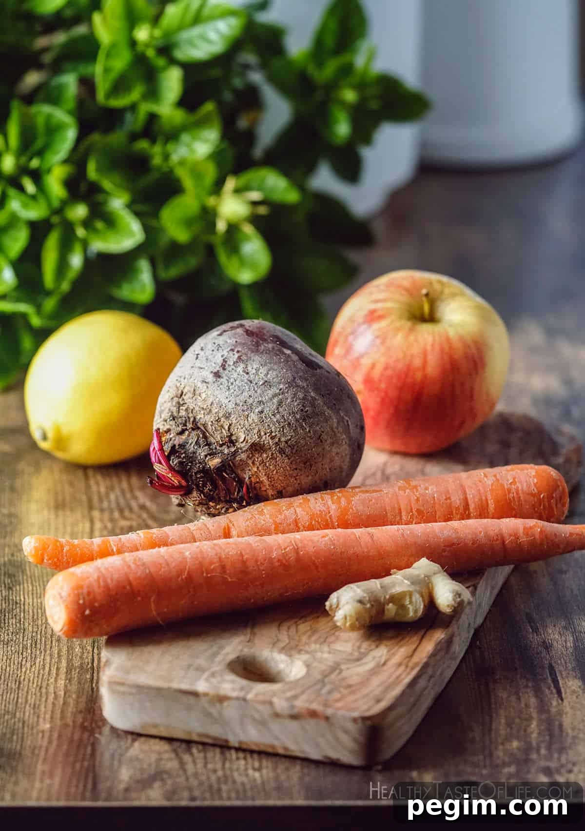 Beetroot Juice Recipes: 2 Ways and Flavor Pairings 3 Picture showing the ingredients used in this beetroot juice recipe: Whole beets carrots apple lemon ginger prepared for juicing.