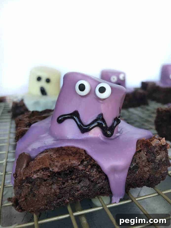 Monster Bash Brownies Recipe and Halloween Traditions 2 purple marshmallow monster brownie on cooling rack