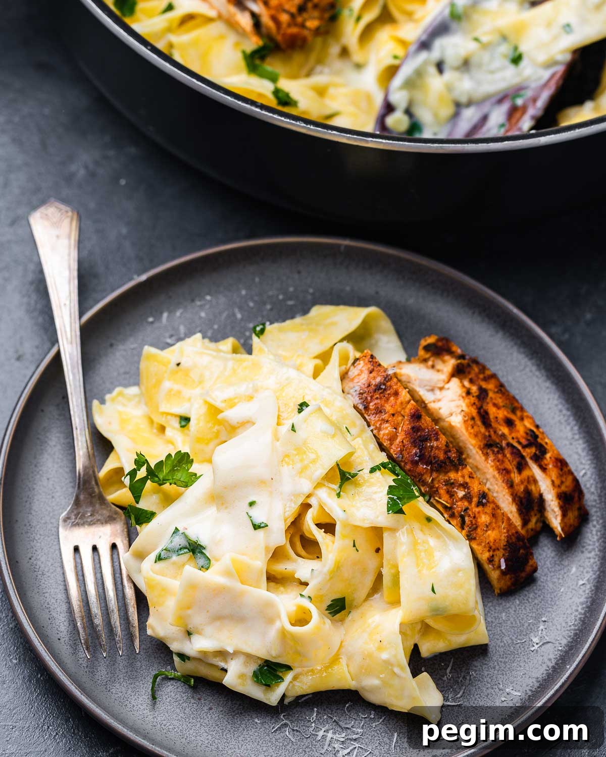 Creamy Chicken Alfredo Pasta Recipe 5 Grey plate with chicken alfredo pappardelle.