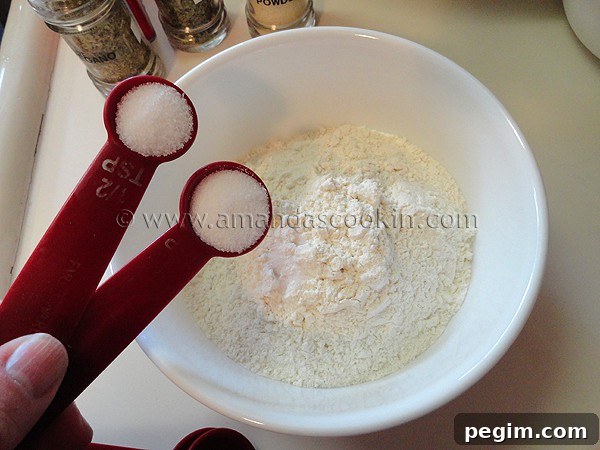 homemade-chicken-nuggets-step-6 A photo of salt being added to flour in a bowl.