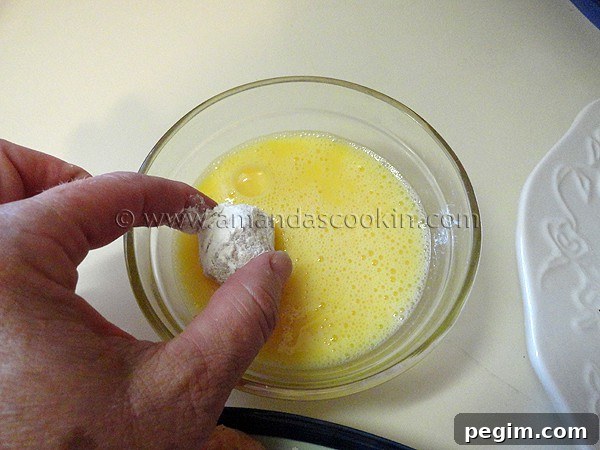 homemade-chicken-nuggets-step-10 A photo of the floured ball being coated with egg.