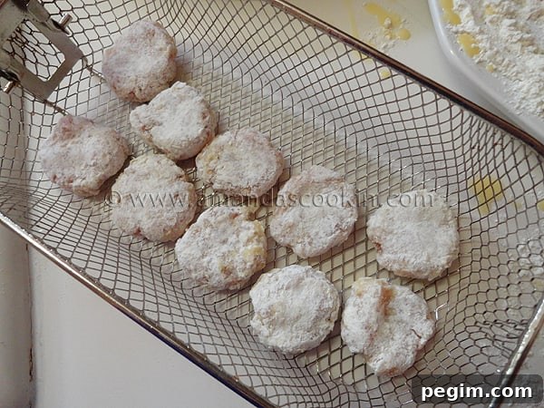 homemade-chicken-nuggets-step-14 A photo of raw chicken nuggets in a frying basket.