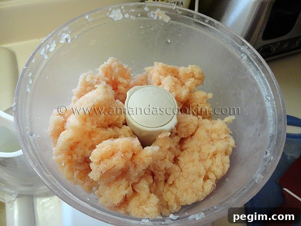 homemade-chicken-nuggets-step-2 A photo of raw chicken in a food processor.