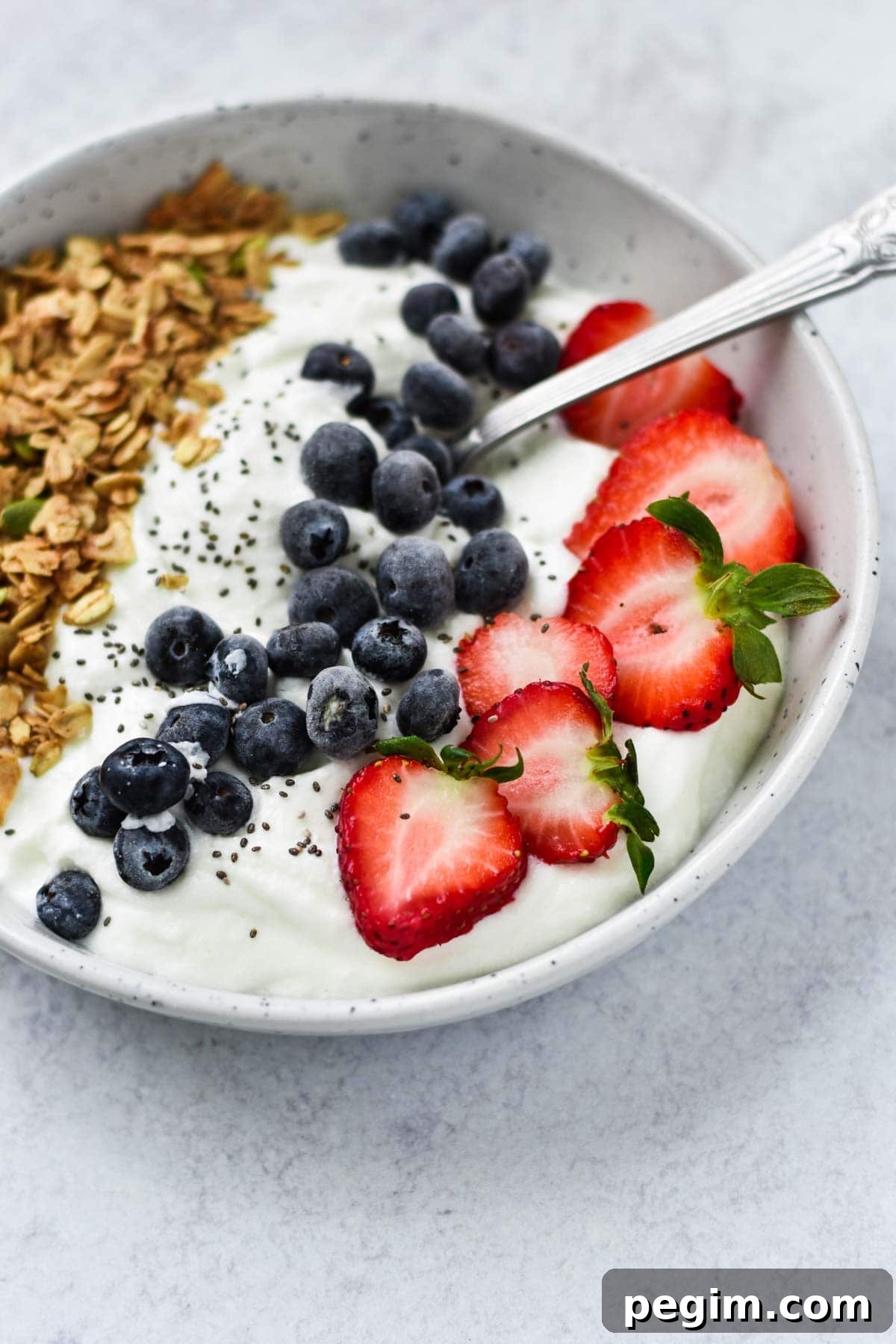 Cottage Cheese with Fruit: Tasty Breakfast and Snack Ideas 2 Cottage cheese topped with mixed berries and granola in a white bowl.