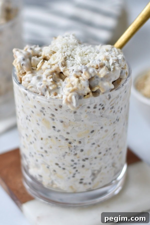Cottage Cheese with Fruit: Tasty Breakfast and Snack Ideas 14 A gold spoon in coconut overnight oats.