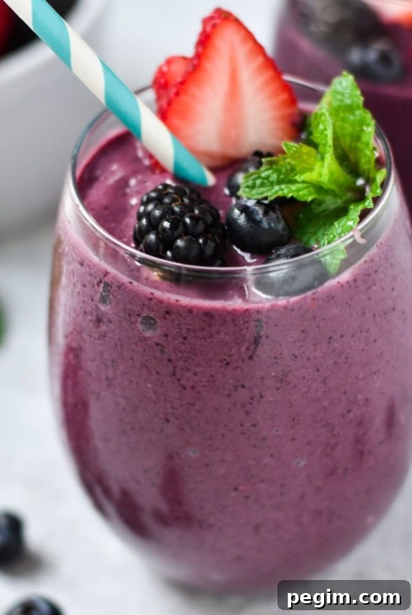 Cottage Cheese with Fruit: Tasty Breakfast and Snack Ideas 15 A berry smoothie with mixed berries on top.