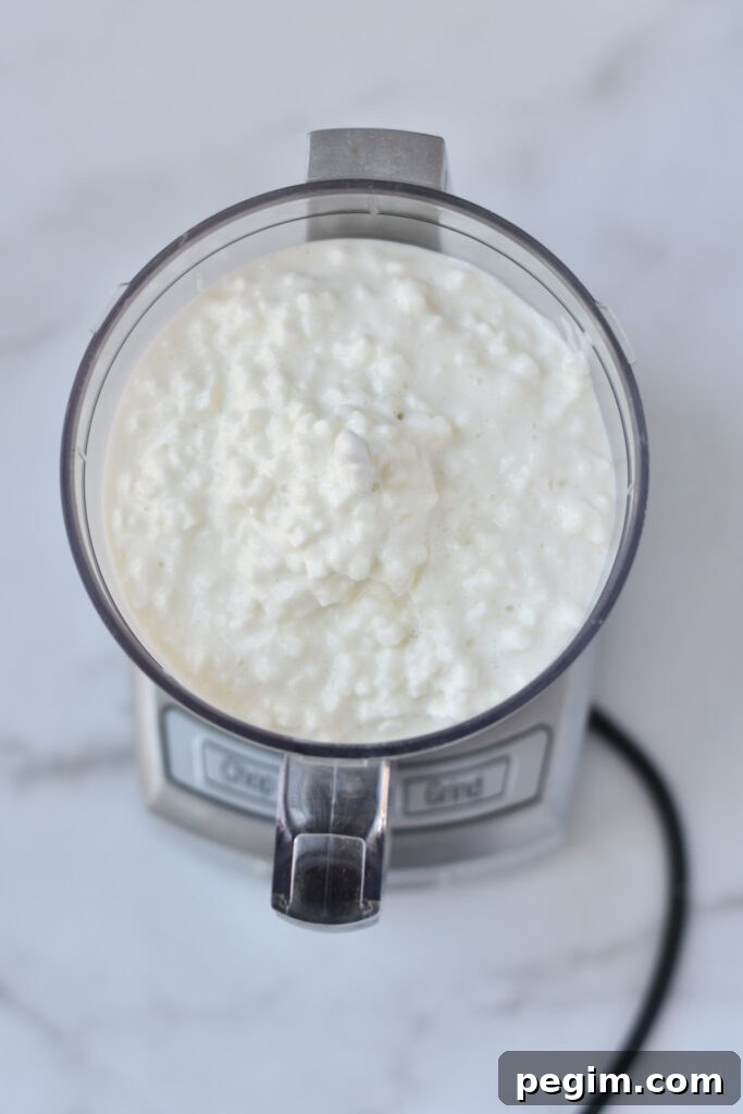 Cottage Cheese with Fruit: Tasty Breakfast and Snack Ideas 5 Cottage cheese in a food processor before whipping.
