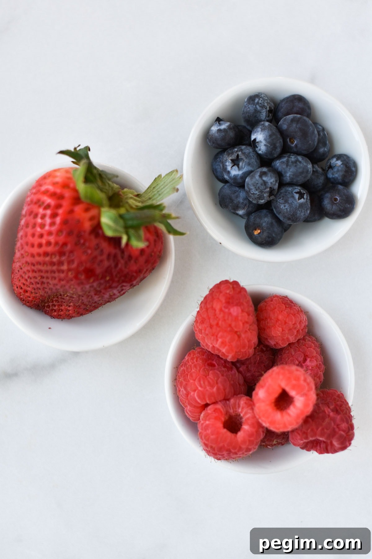 Cottage Cheese with Fruit: Tasty Breakfast and Snack Ideas 9 Strawberries, blueberries, and raspberries in small cups.