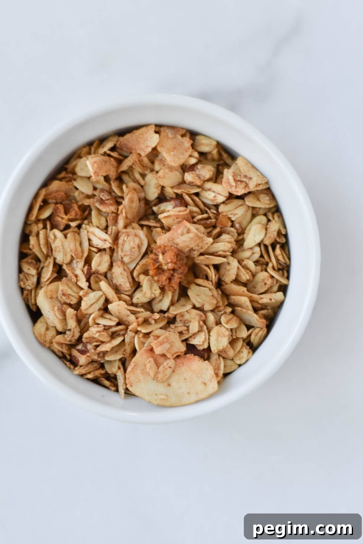 Cottage Cheese with Fruit: Tasty Breakfast and Snack Ideas 10 A cup of granola on a marble background.