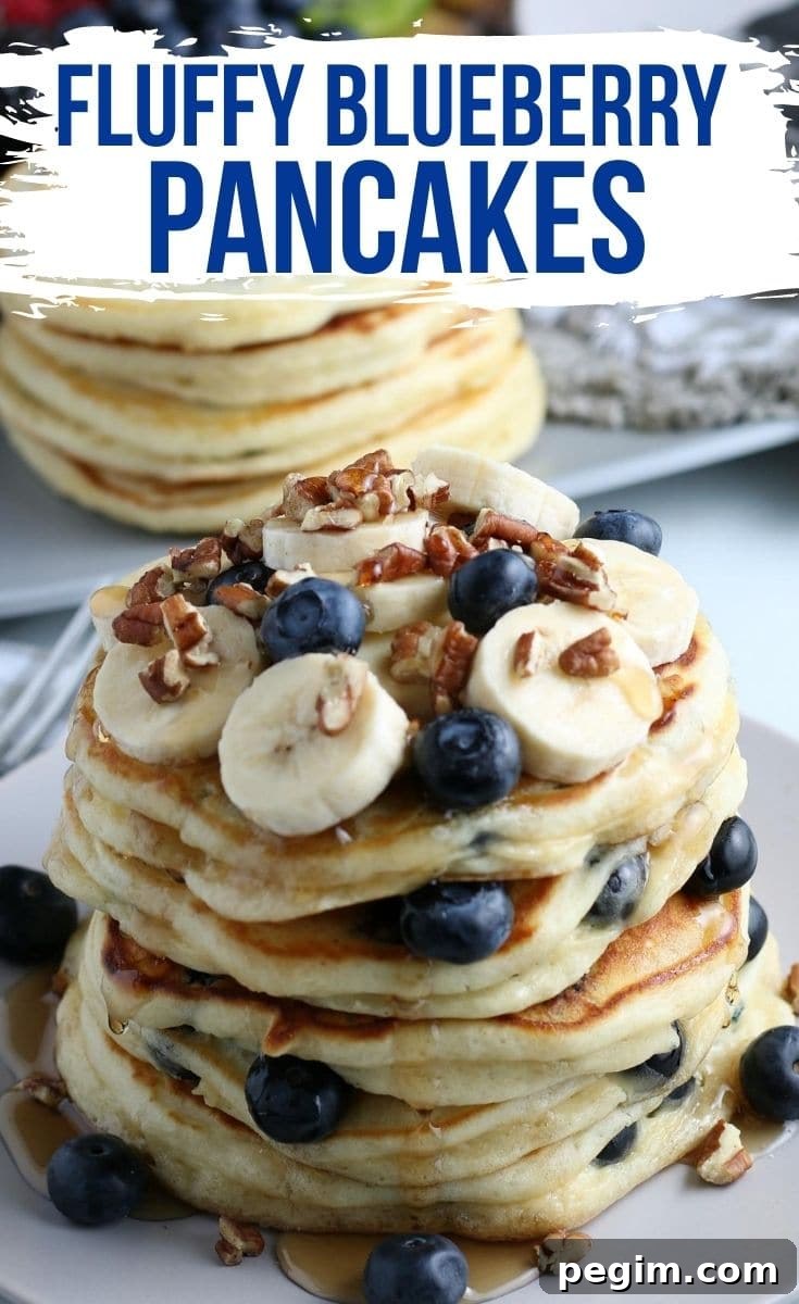 Fluffy Homemade Blueberry Pancakes 2 A stack of blueberry pancakes topped with bananas, blueberries, and walnuts