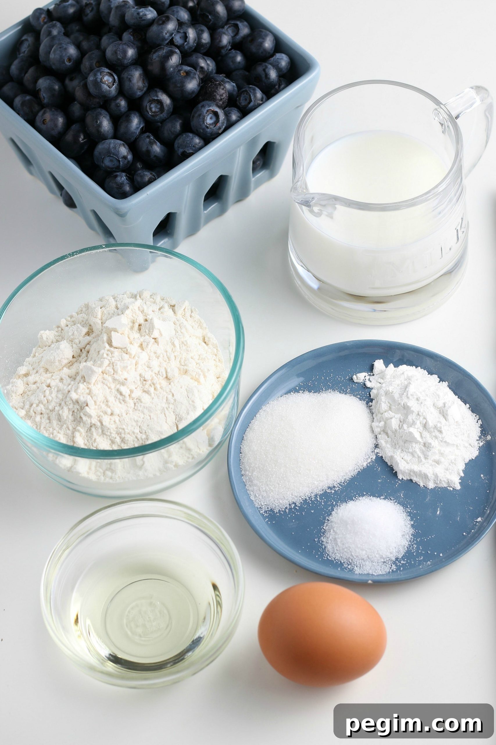 Fluffy Homemade Blueberry Pancakes 3 ingredients for homemade blueberry pancakes on a white countertop