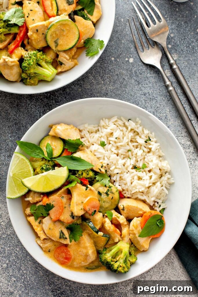 Authentic Thai Chicken Curry with Coconut Milk 6 Bowls filled with Thai red curry with coconut milk and veggies served with rice.