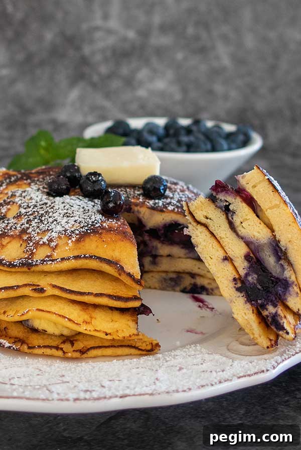 Gluten-Free Brunch Recipes for Weekend Guests 6 stack of coconut flour pancakes and fresh blueberries.