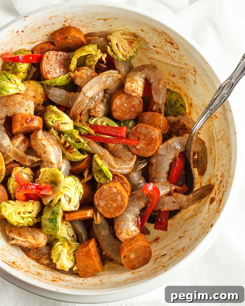 Sheet Pan Shrimp and Sausage Dinner 6 Mixing ingredients together.