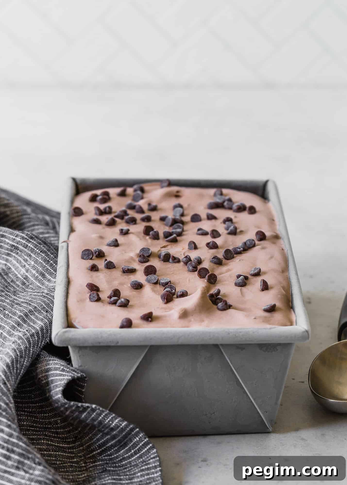 Creamy and smooth homemade chocolate ice cream is easy to make without an ice cream maker! Add chocolate chips for double the chocolate. Chocolate ice cream in a loaf pan.