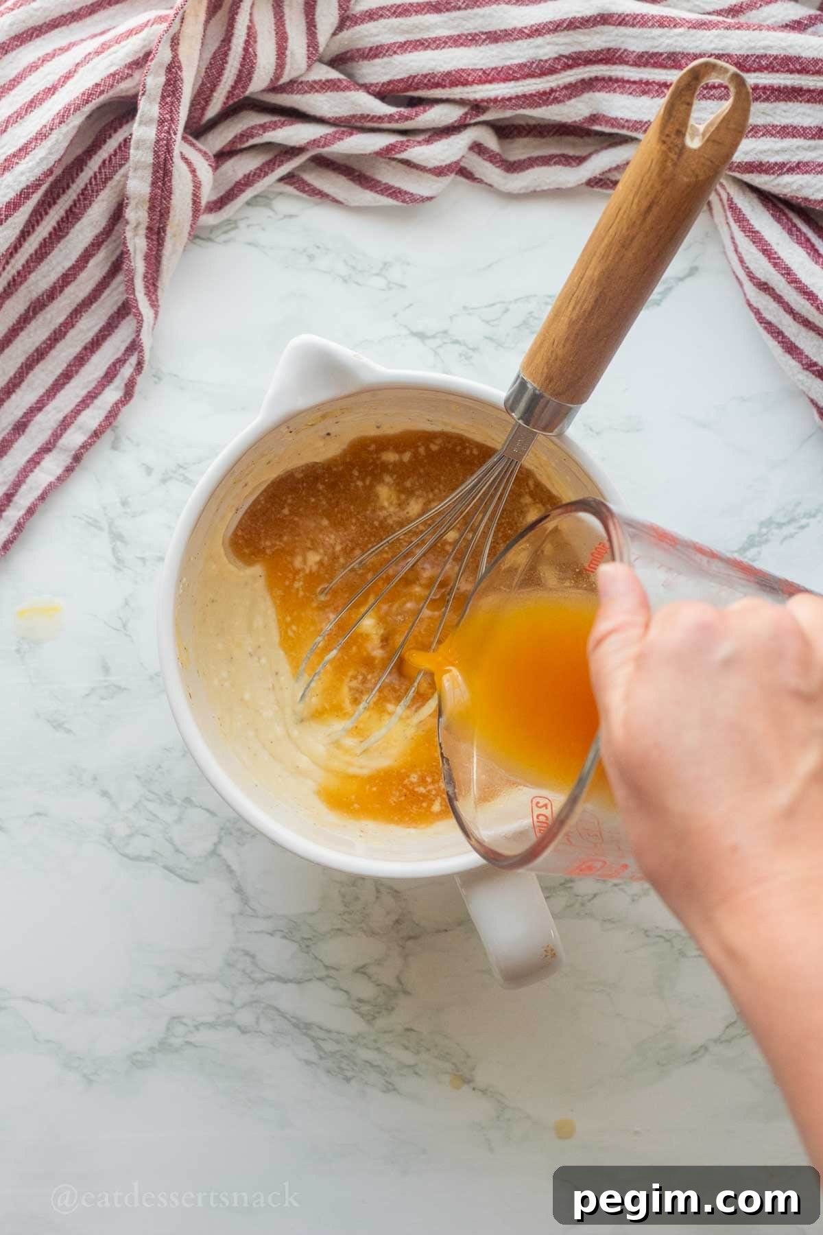 Homemade Apple Cinnamon Donuts with Spiced Glaze 6 Pouring apple cider into measuring cup.