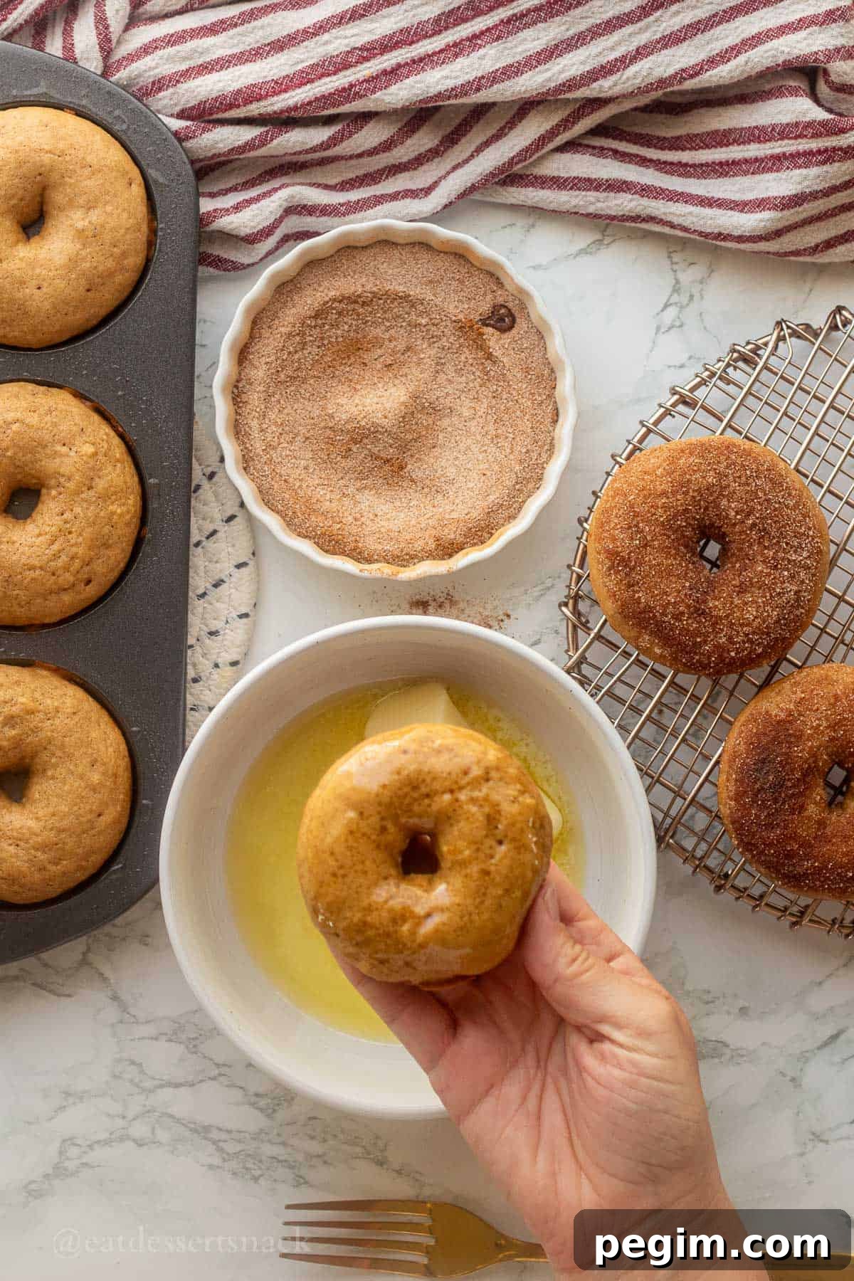 Homemade Apple Cinnamon Donuts with Spiced Glaze 9 Dipping baked donuts in butter then cinnamon sugar.
