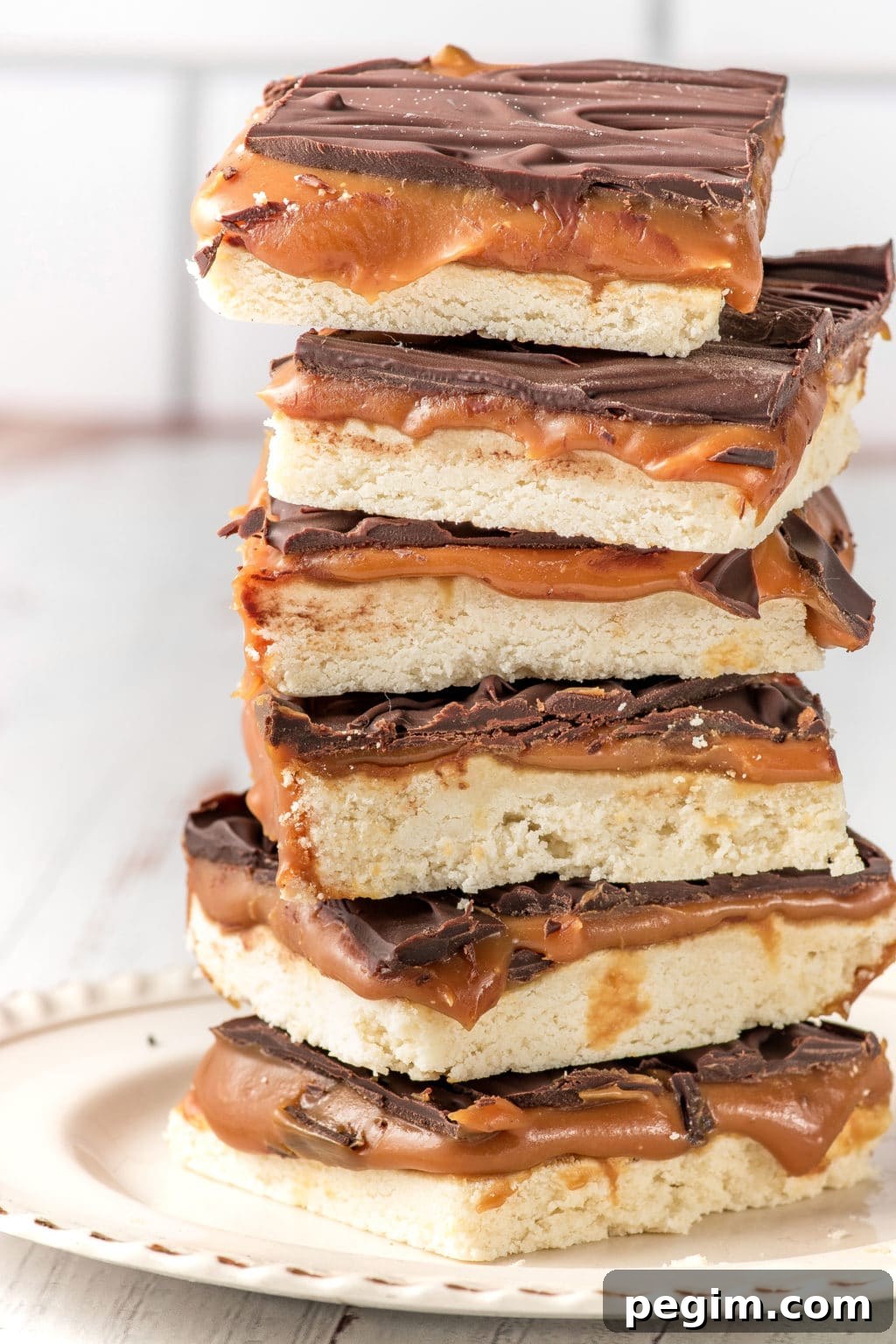 A stack of keto-friendly millionaire bars stacked on a white plate