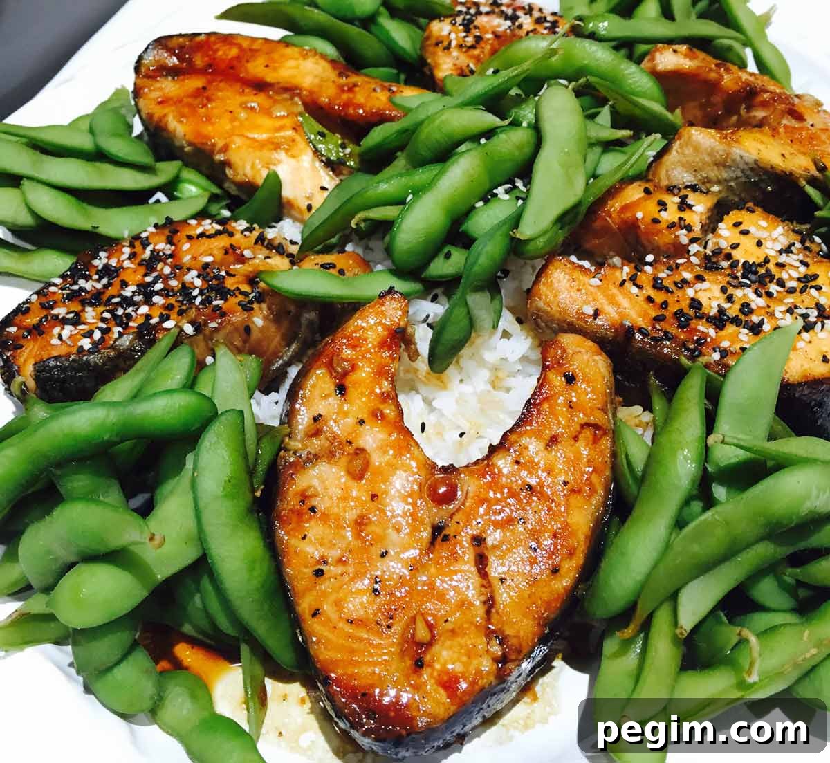 Teriyaki Salmon with Edamame and Steamed Rice 2 Salmon teriyaki with edamame and rice, on a white plate