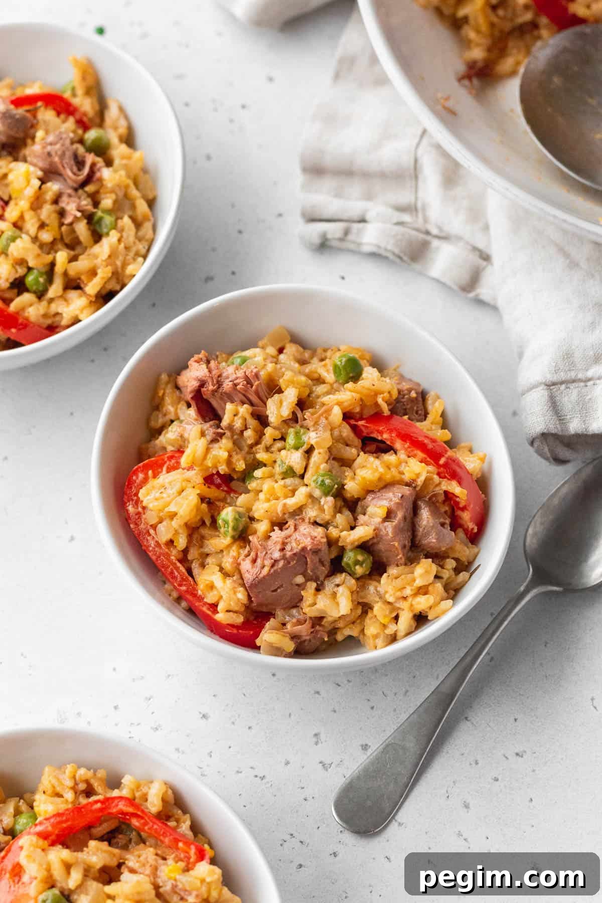 Vegan Arroz a la Valenciana: Spanish-Style Rice with Vegetables 3 3 small bowls of Arroz a la Valenciana on a white surface.
