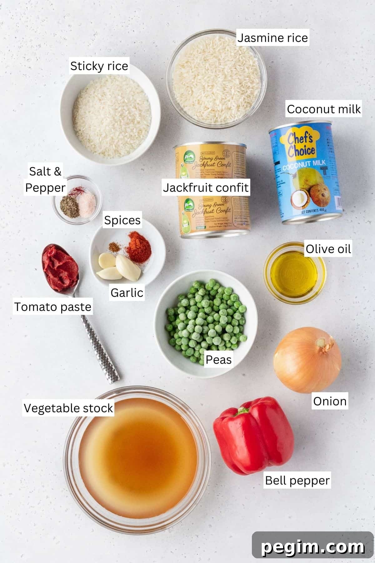 Vegan Arroz a la Valenciana: Spanish-Style Rice with Vegetables 4 Ingredients for making vegan Arroz Valenciana laid out on a table with text overlay.