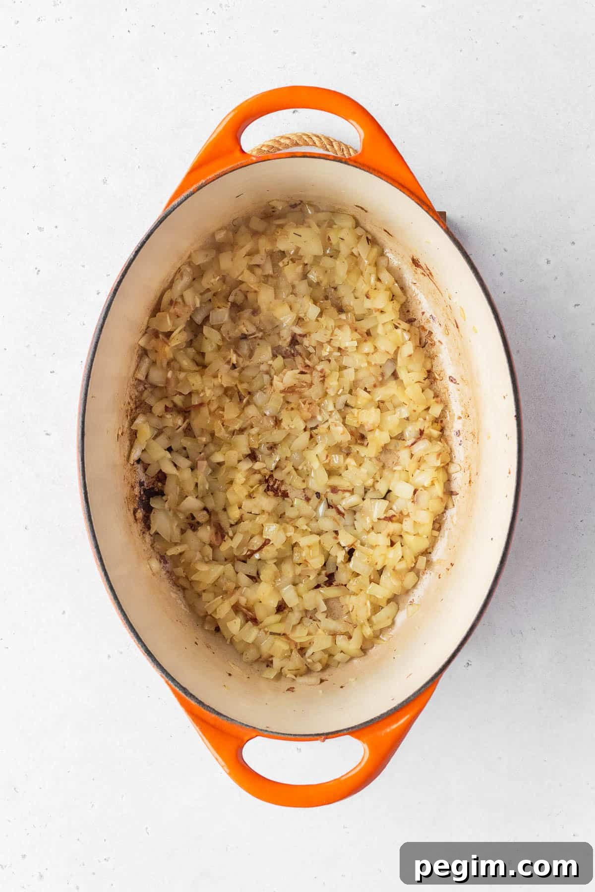 Vegan Arroz a la Valenciana: Spanish-Style Rice with Vegetables 6 Minced onion and garlic cooking in a large enameled pot.