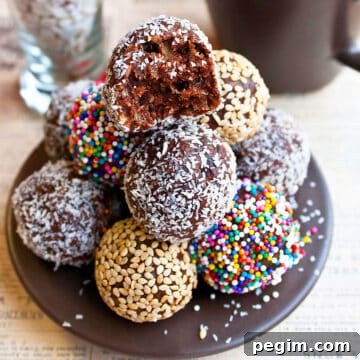 Stack of Easy Chocolate Date Balls With Various Toppings on Brown Dish.