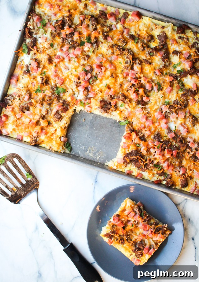 Sliceable sheet pan breakfast pizza with melted cheese and egg