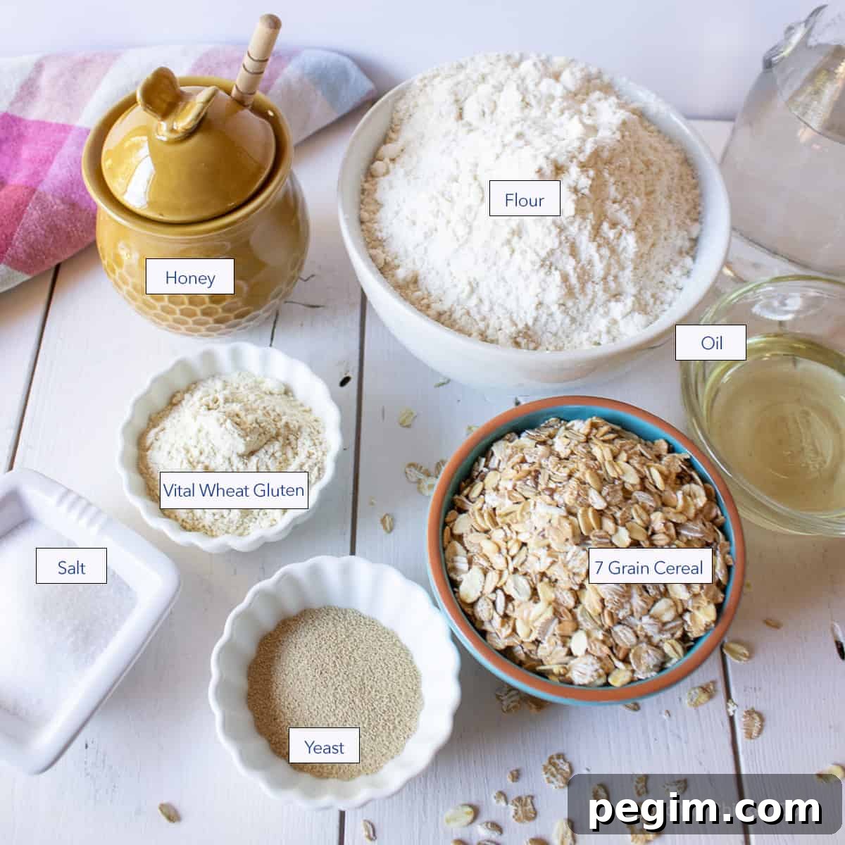 Soft Homemade White Wheat Bread Recipe 3 Small bowls filled with flour, oats and other ingredients.