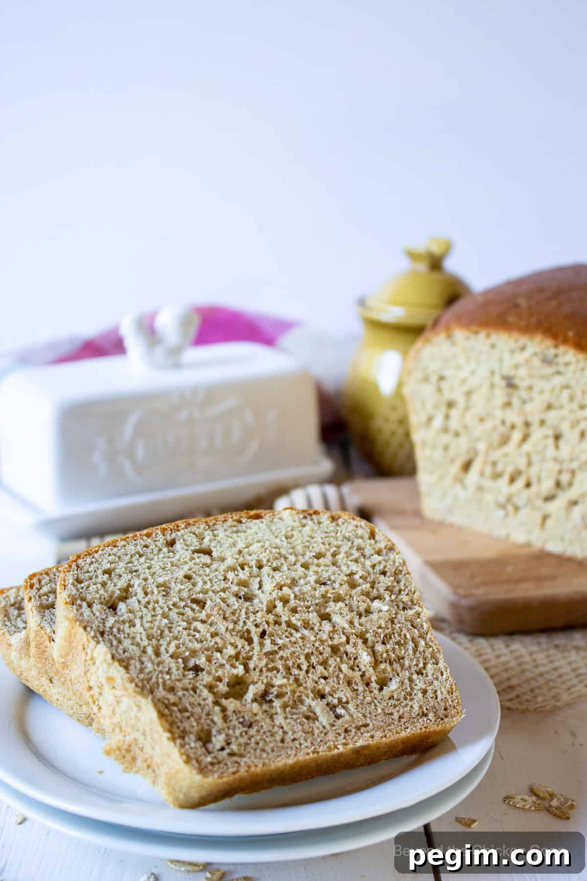 Soft Homemade White Wheat Bread Recipe 7 Sliced whole wheat bread on a small white plate.