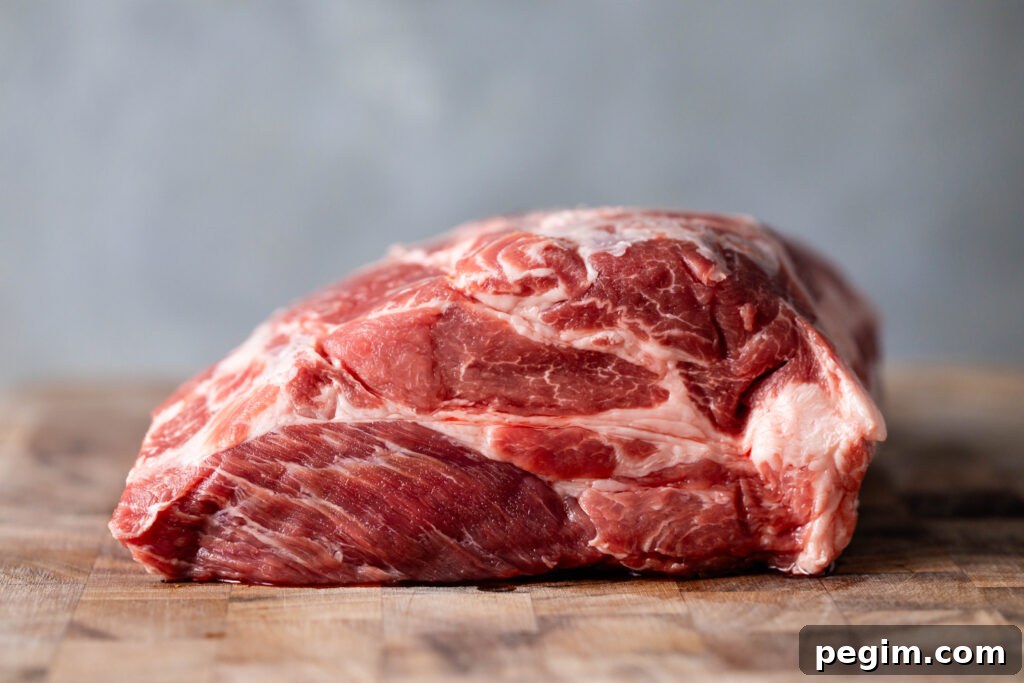 raw pork coppa roast on a cutting board